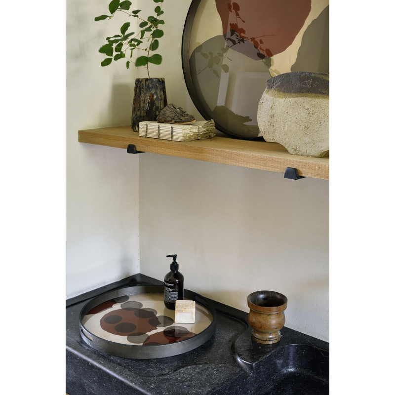 The small Layered Dots Glass Tray from Ethnicraft in a bathroom.