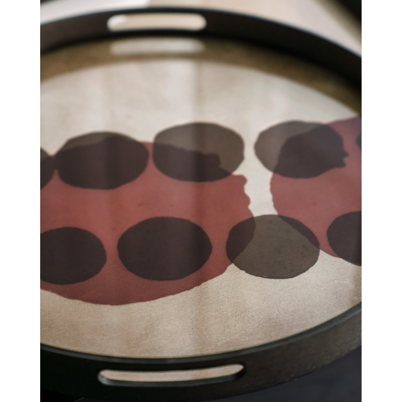 The small round Layered Dots Glass Tray from Ethnicraft in a living room.