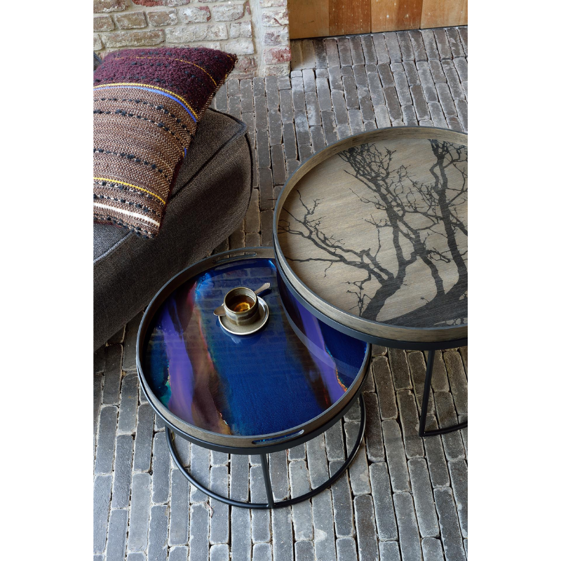 The round indigo Organic Glass Tray from Ethnicraft in a living room.