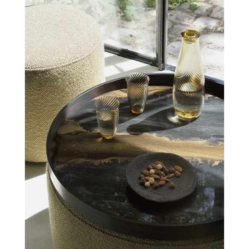 The medium bronze round Organic Glass Tray from Ethnicraft in a dining setting.