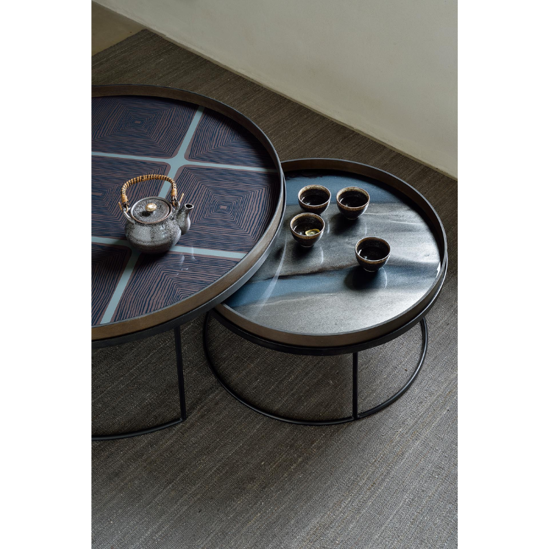 The medium graphite round Organic Glass Tray from Ethnicraft used for a tea table.
