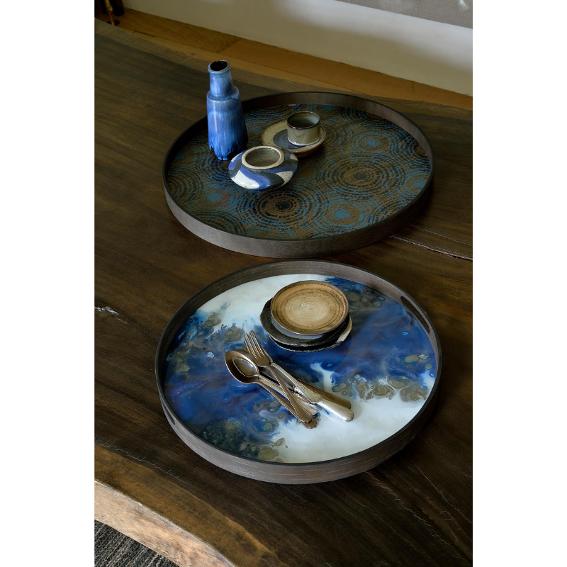 The round blue mist Organic Glass Tray from Ethnicraft in dining room.