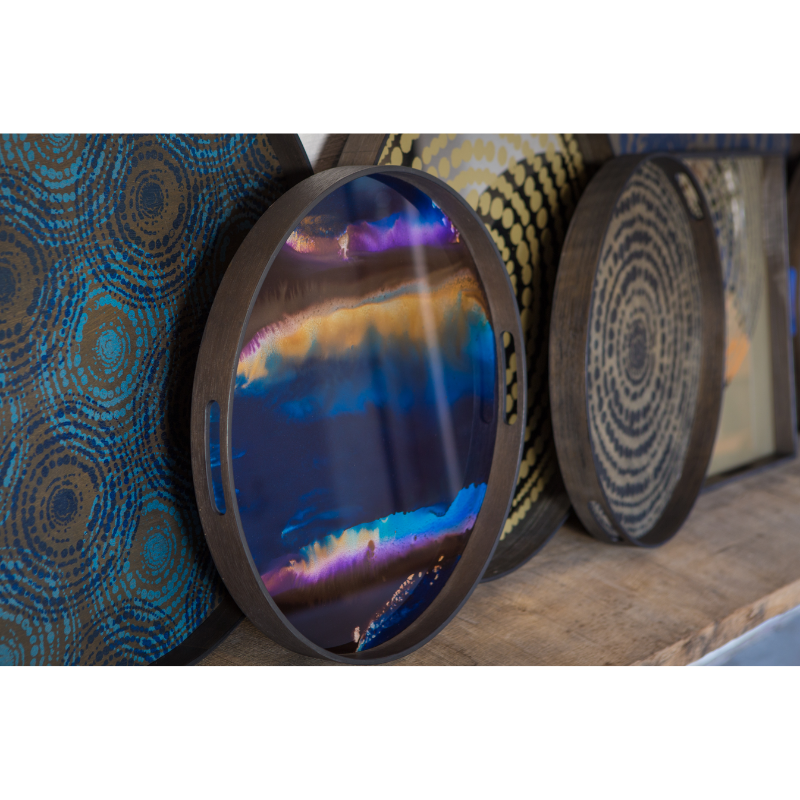 The round indigo Organic Glass Tray from Ethnicraft with a variety of trays.