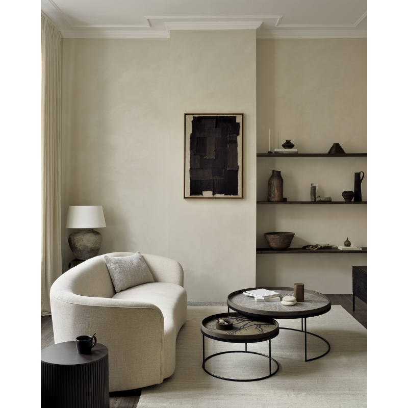 The white round Slice Wooden Tray from Ethnicraft in a lounge.