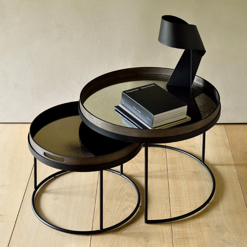 The medium and large Round Tray Coffee Table Set from Ethnicraft in a family space.