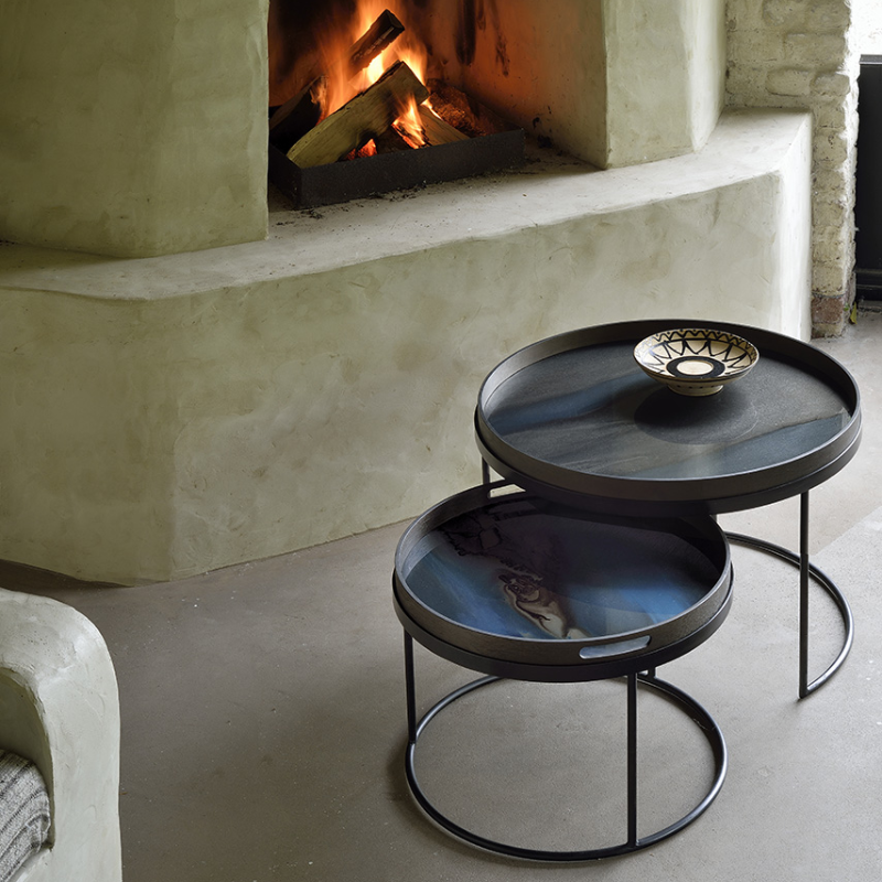 The small and medium Round Tray Coffee Table Set from Ethnicraft in a lounge.