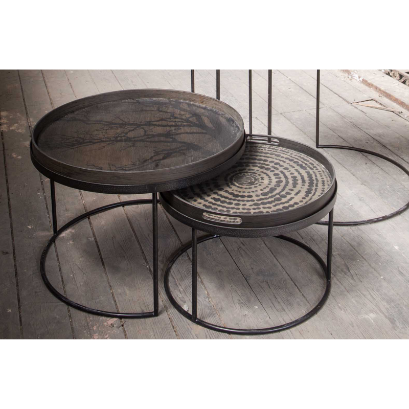 The black Round Tree Wooden Tray from Ethnicraft in a living room.
