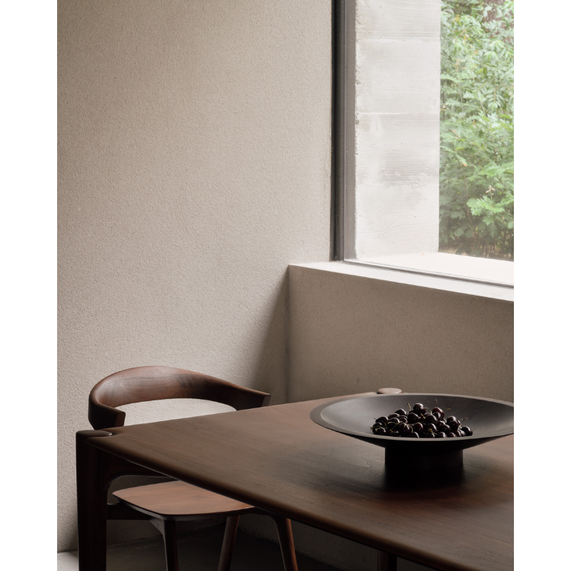 The Satellite Bowl from Ethnicraft in a dining space, holding cherries.