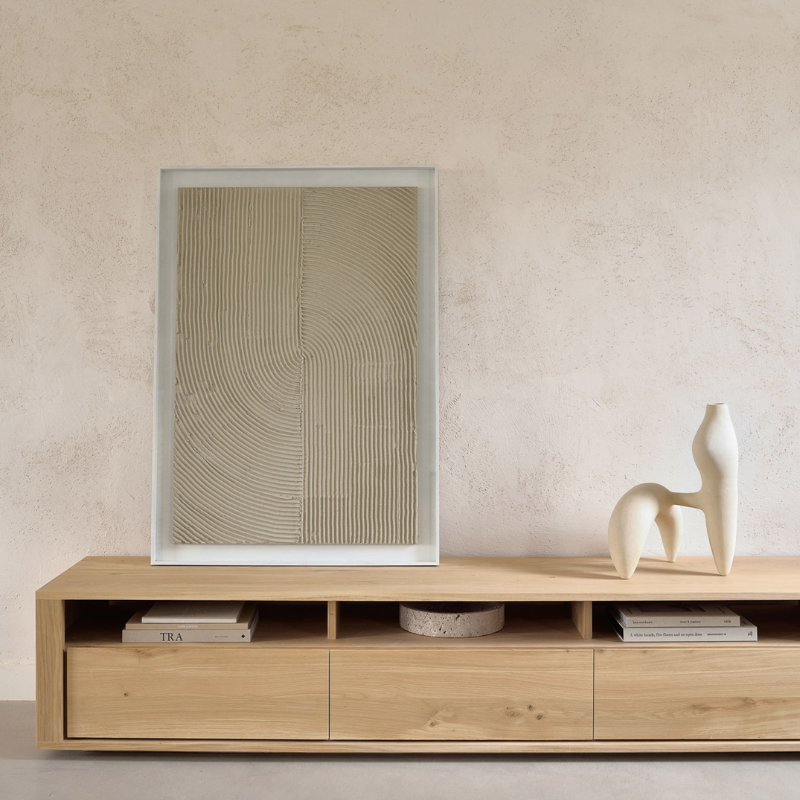 The Shadow TV Cupboard from Ethnicraft in a bedroom.