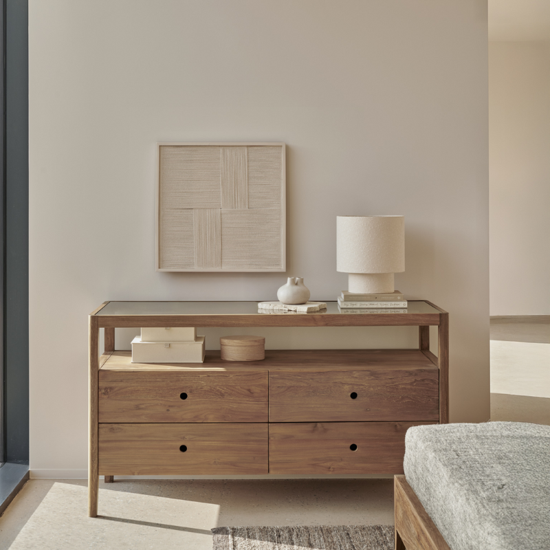 The Spindle Dresser from Ethnicraft in reclaimed teak in a primary bedroom.