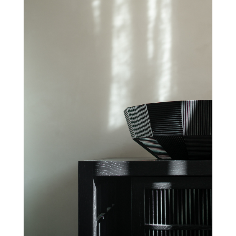 The Striped Bowl from Ethnicraft in a living room.