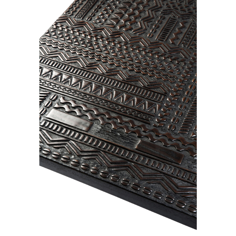 The Tabwa Coffee Table from Ethnicraft in a photograph highlighting the hand carved tabletop.