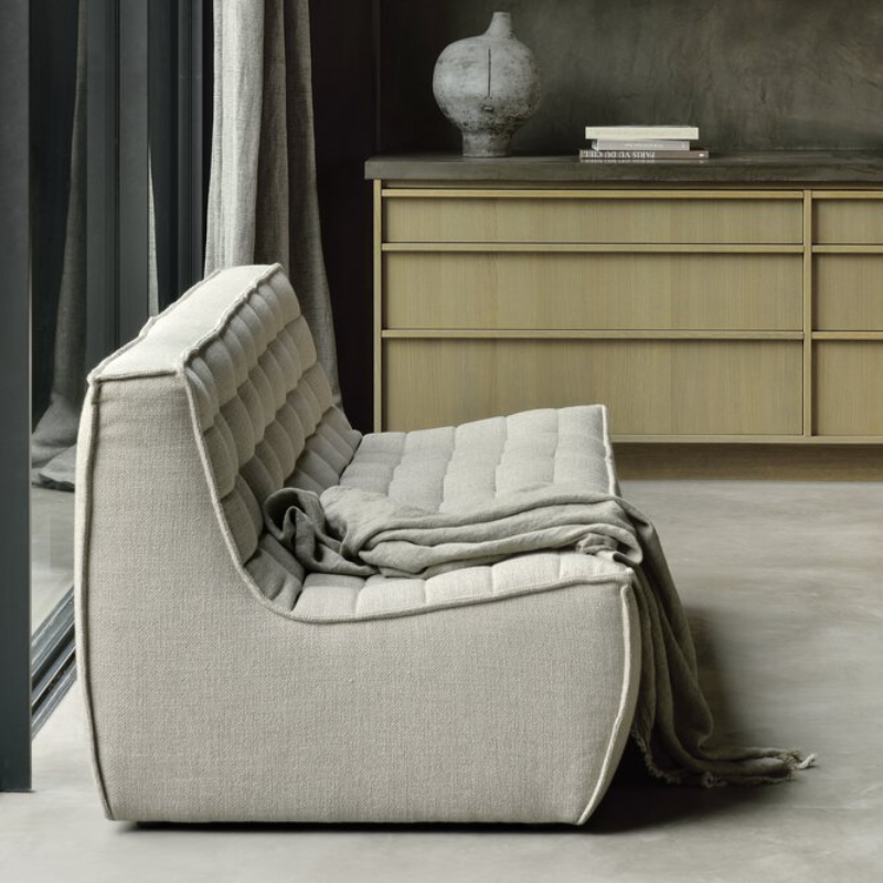 The N701 Three Seater Sofa from Ethnicraft with beige standard fabric in a living room.
