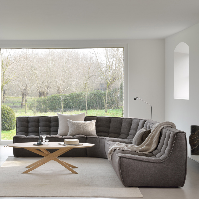 The N701 Three Seater Sofa from Ethnicraft with dark grey standard fabric in a family area.
