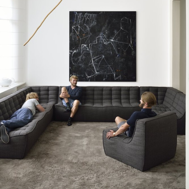 The N701 Three Seater Sofa from Ethnicraft with dark grey standard fabric in a lifestyle.