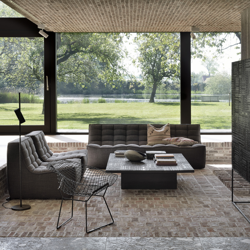 The N701 Three Seater Sofa from Ethnicraft with dark grey standard fabric in a living room.