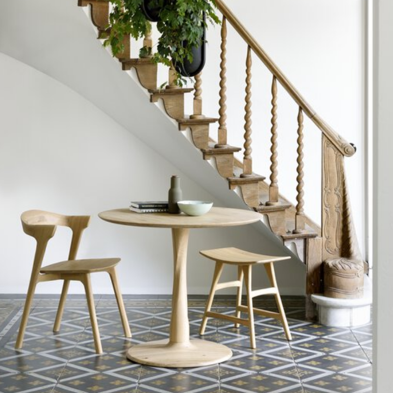 Illuminee Torsion Round Dining Table Oak by Ethnicraft in a personal family space.