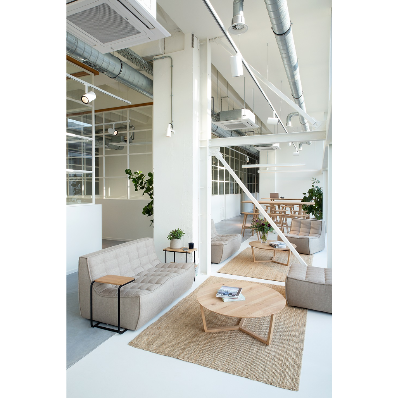 The Tripod Coffee Table from Ethnicraft in a lounge.