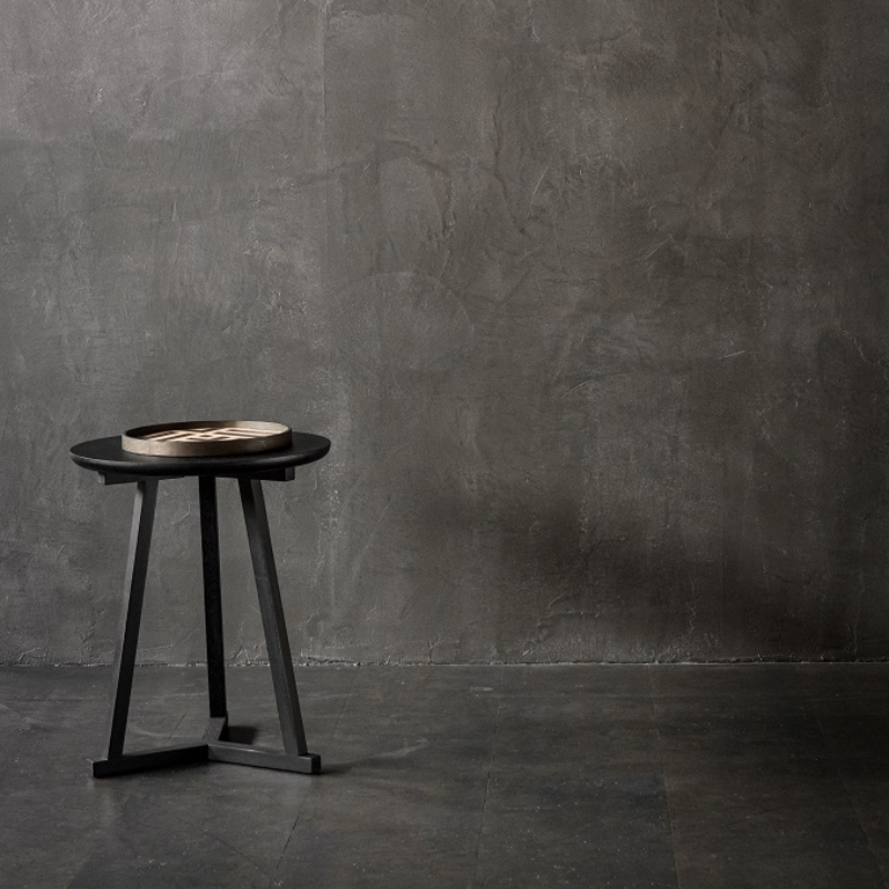 The Tripod Side Table from Ethnicraft in black oak in a living space.