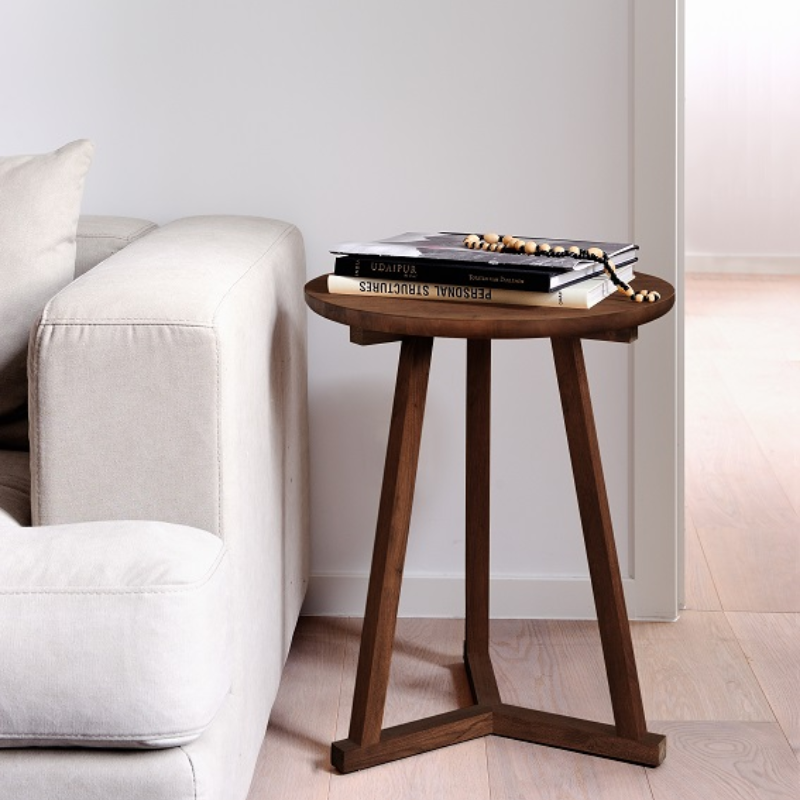 The Tripod Side Table from Ethnicraft in teak in a family area.