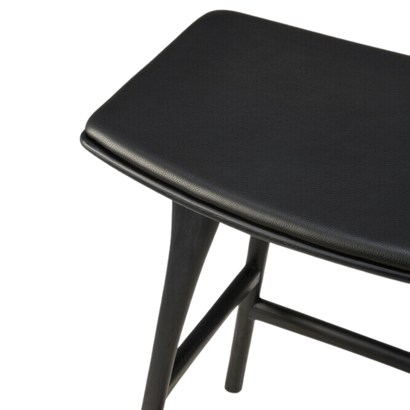 The Upholstered Osso Counter Stool from Ethnicraft with black oak wood and black leather seat.