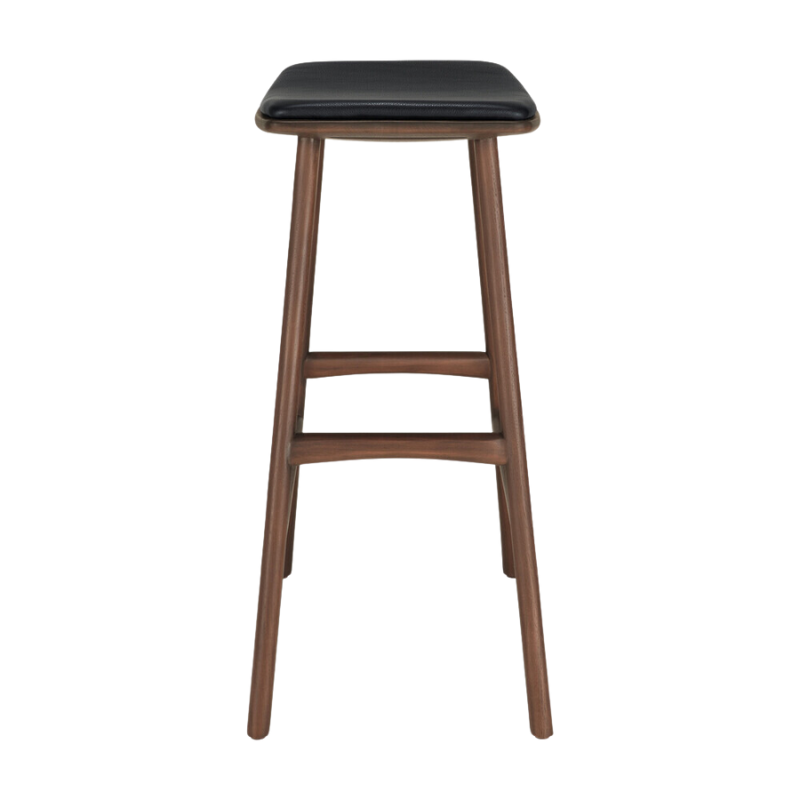 The Upholstered Osso Counter Stool from Ethnicraft with brown teak wood and black leather from the side.