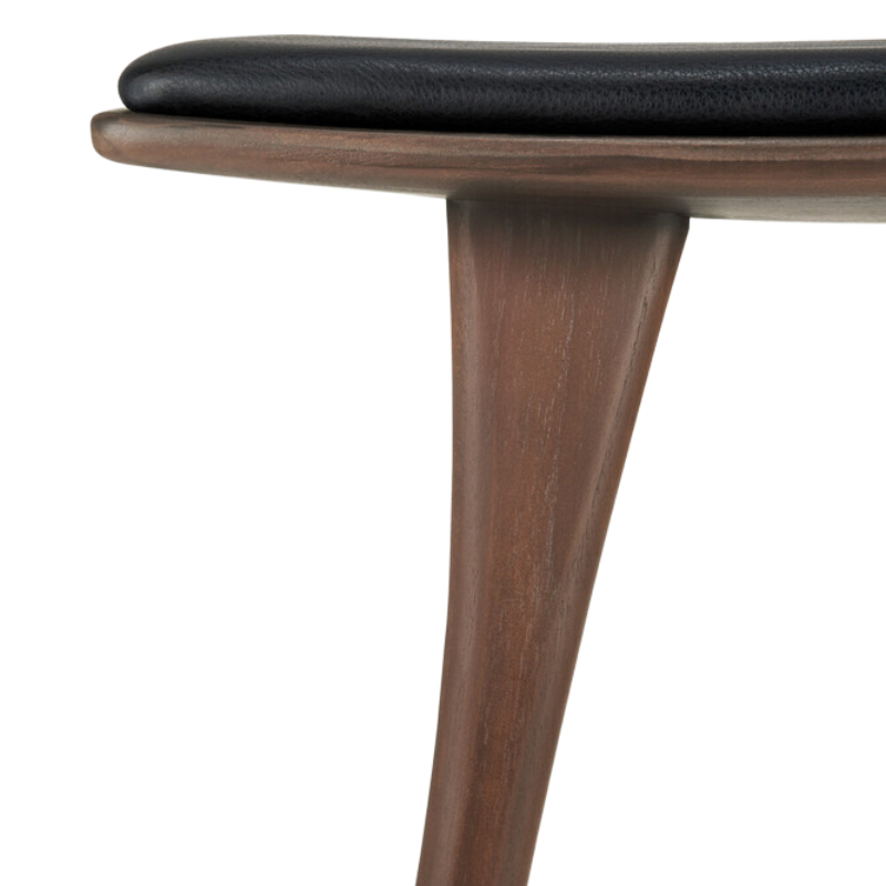 The Upholstered Osso Counter Stool from Ethnicraft with brown teak wood and black leather upholstery.