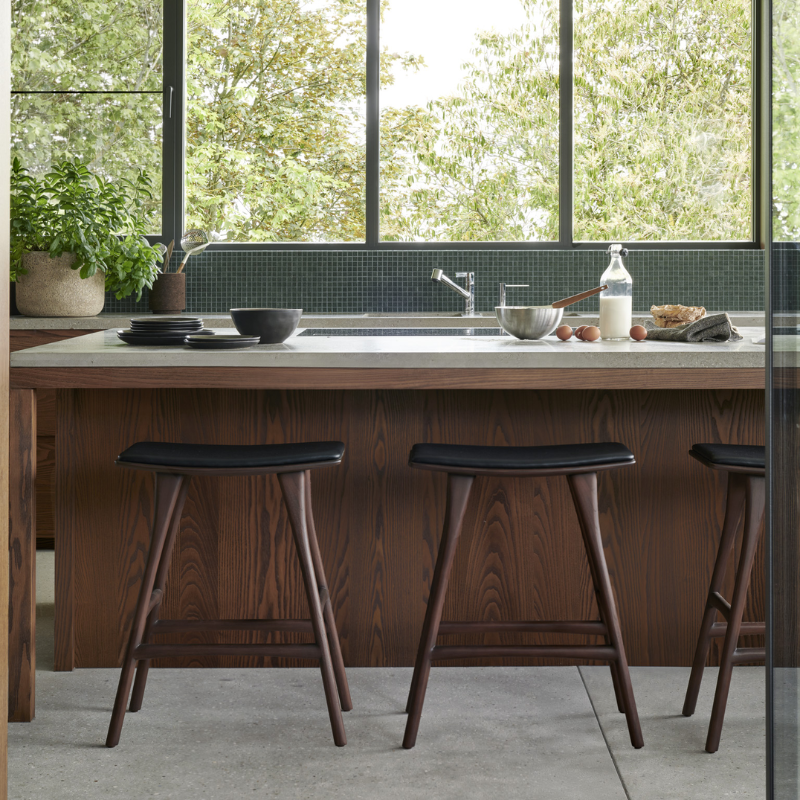 The Upholstered Osso Counter Stool from Ethnicraft at a dining counter.