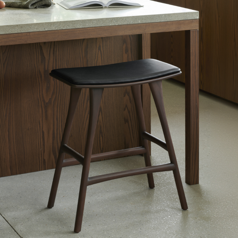 The Upholstered Osso Counter Stool from Ethnicraft in a living room.