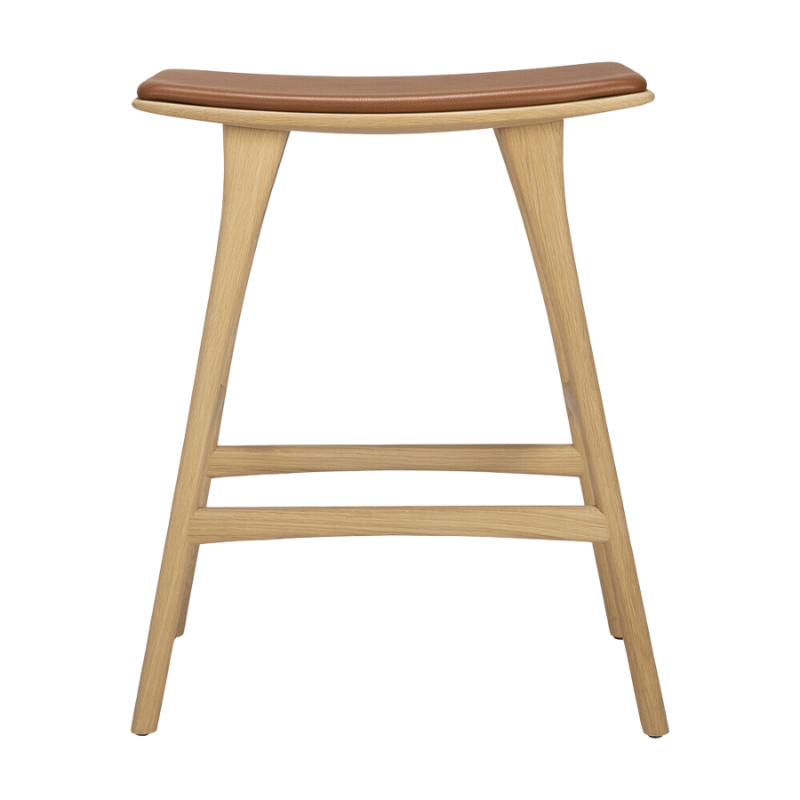 The Upholstered Osso Counter Stool from Ethnicraft with oak wood and cognac leather from the front.