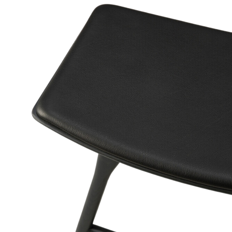 The Upholstered Osso Dining Stool from Ethnicraft with black oak and black leather seat.