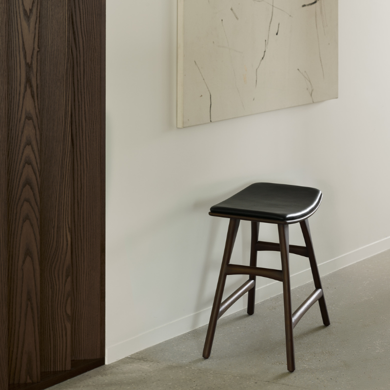 The Upholstered Osso Dining Stool from Ethnicraft in a living room.