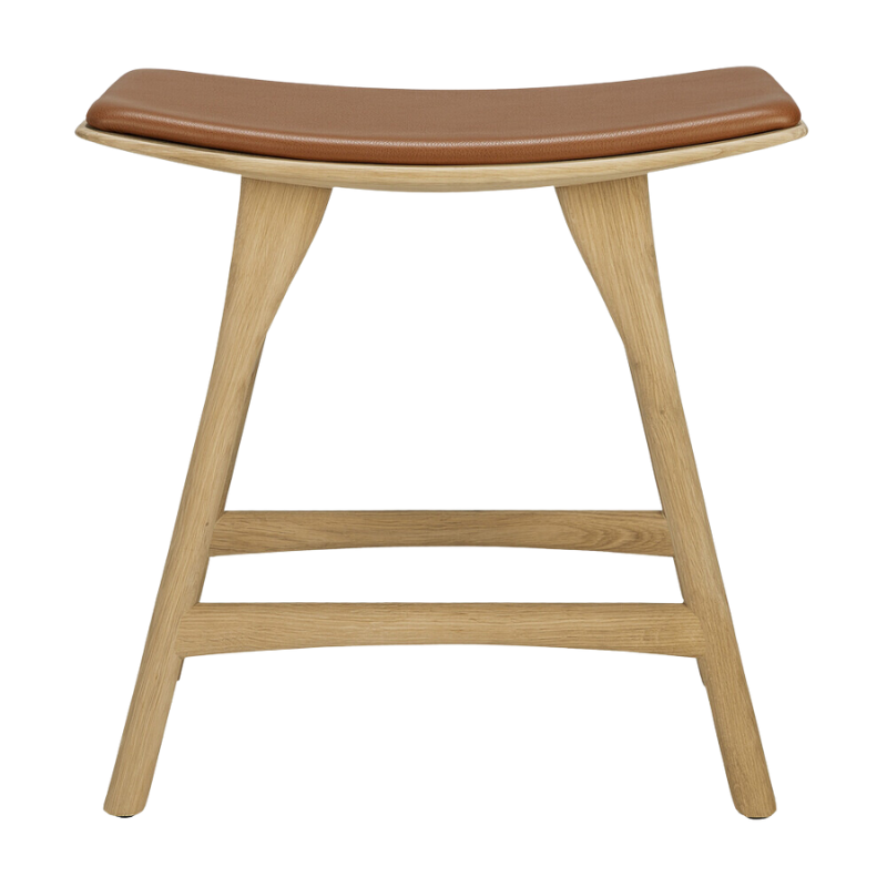 The Upholstered Osso Dining Stool from Ethnicraft with oak and cognac leather from the front.
