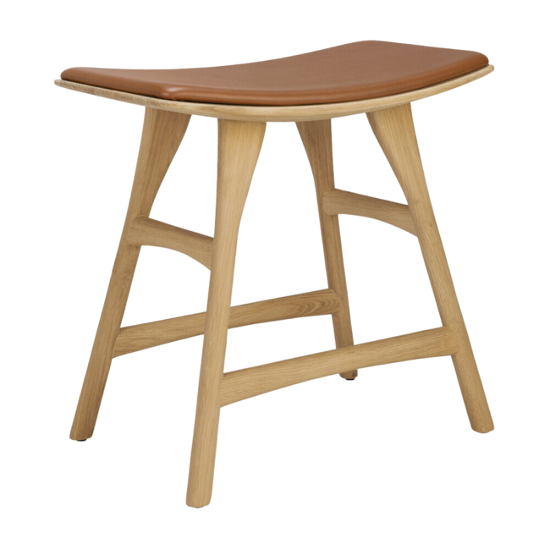 The Upholstered Osso Dining Stool from Ethnicraft with oak and cognac leather.
