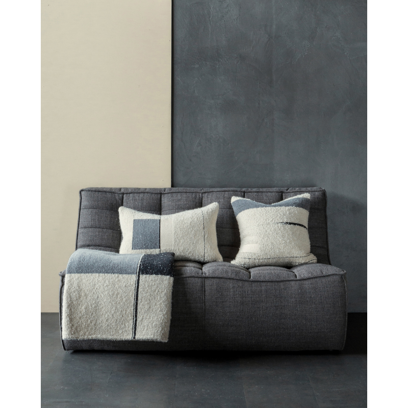The Urban Rectangular Cushion by Ethnicraft in a living room.