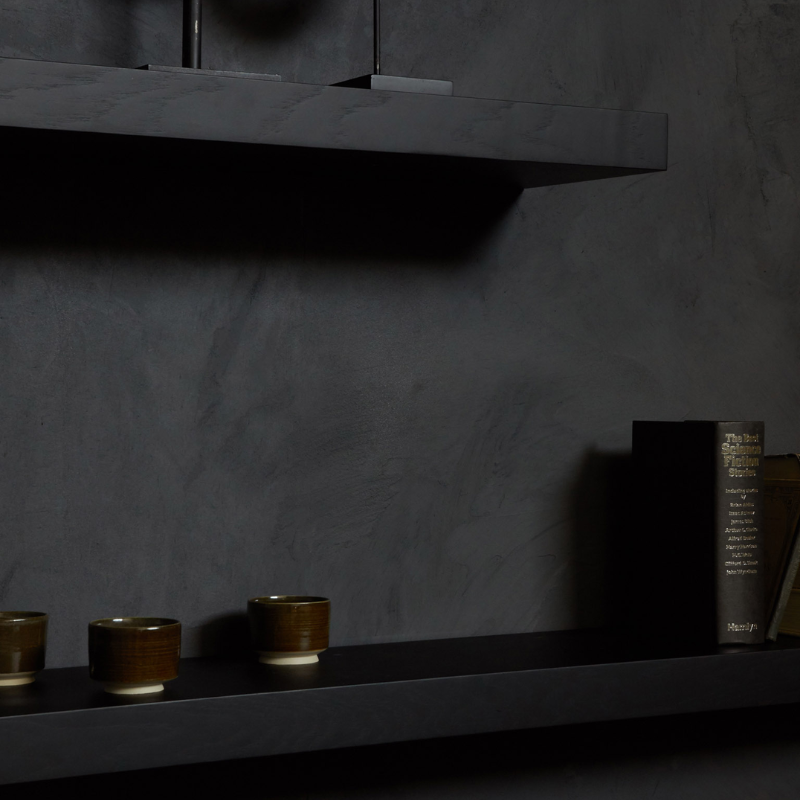 The Wall Shelf from Ethnicraft made with black oak used as a bookshelf.