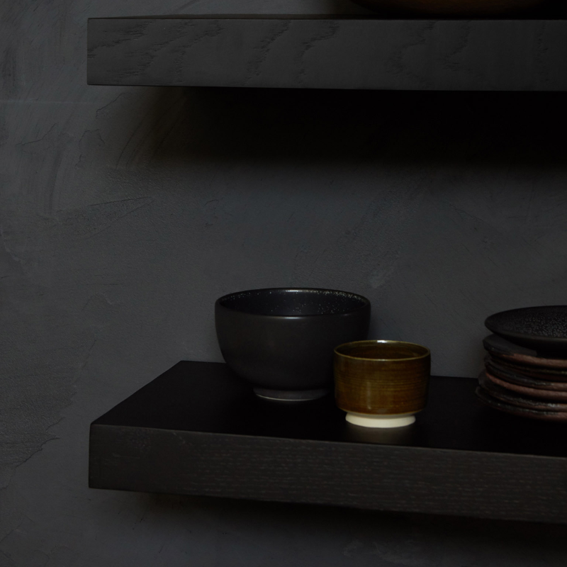 The Wall Shelf from Ethnicraft made with black oak in a kitchen and dining setting.