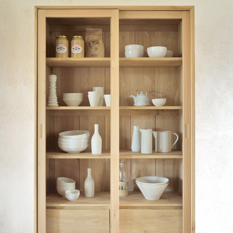 The Wave Cupboard from Ethnicraft in a kitchen and dining setting.