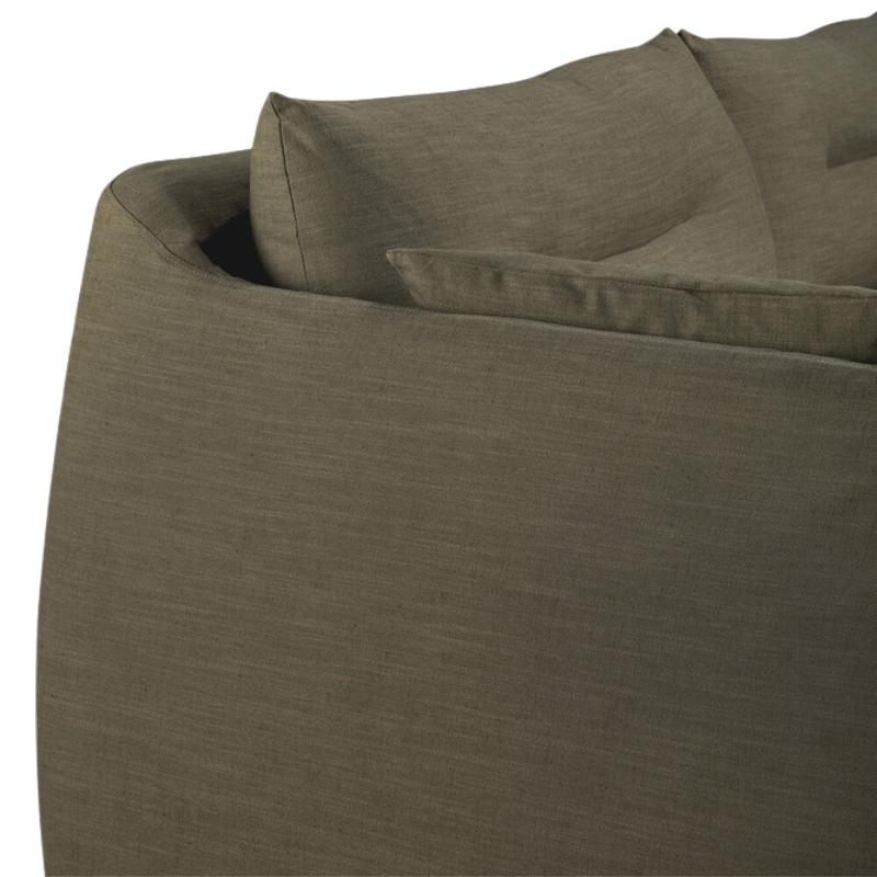 The Green Weave Sofa by Ethnicraft with a curved corner.