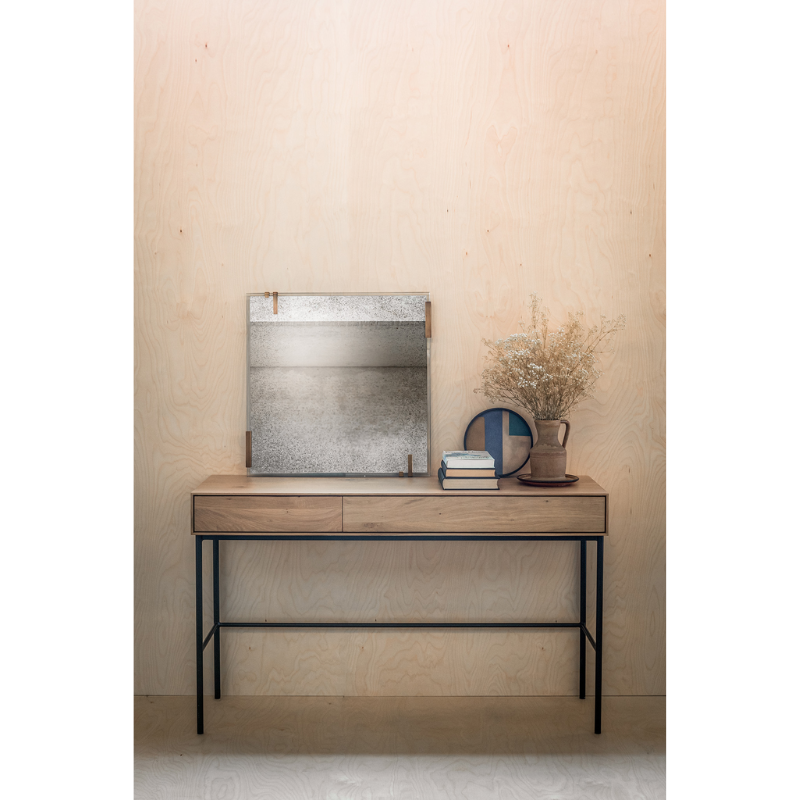 The Whitebird Desk from Ethnicraft in a living room.