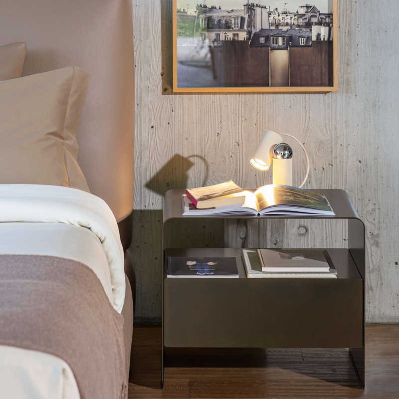 The Bilboquet Table Lamp from FLOS in linen in a bedroom.