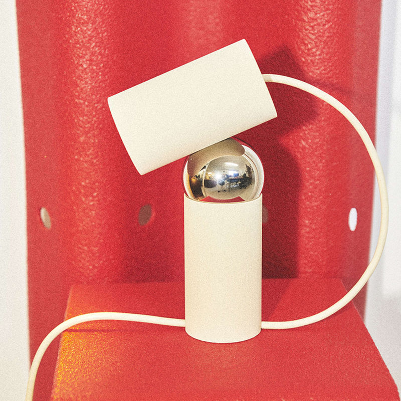 The Bilboquet Table Lamp from FLOS in linen in a living room.