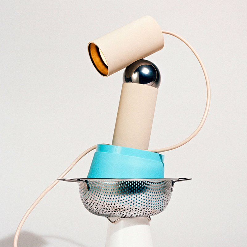 The Bilboquet Table Lamp from FLOS in linen in a studio for a photo shoot.