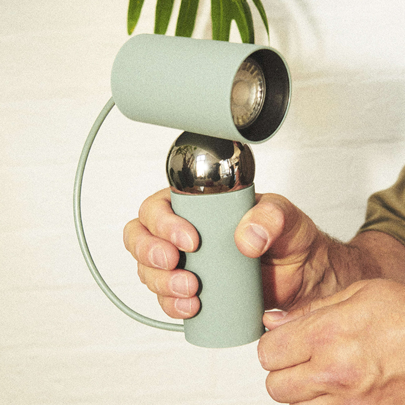 The Bilboquet Table Lamp from FLOS in sage in a lifestyle.