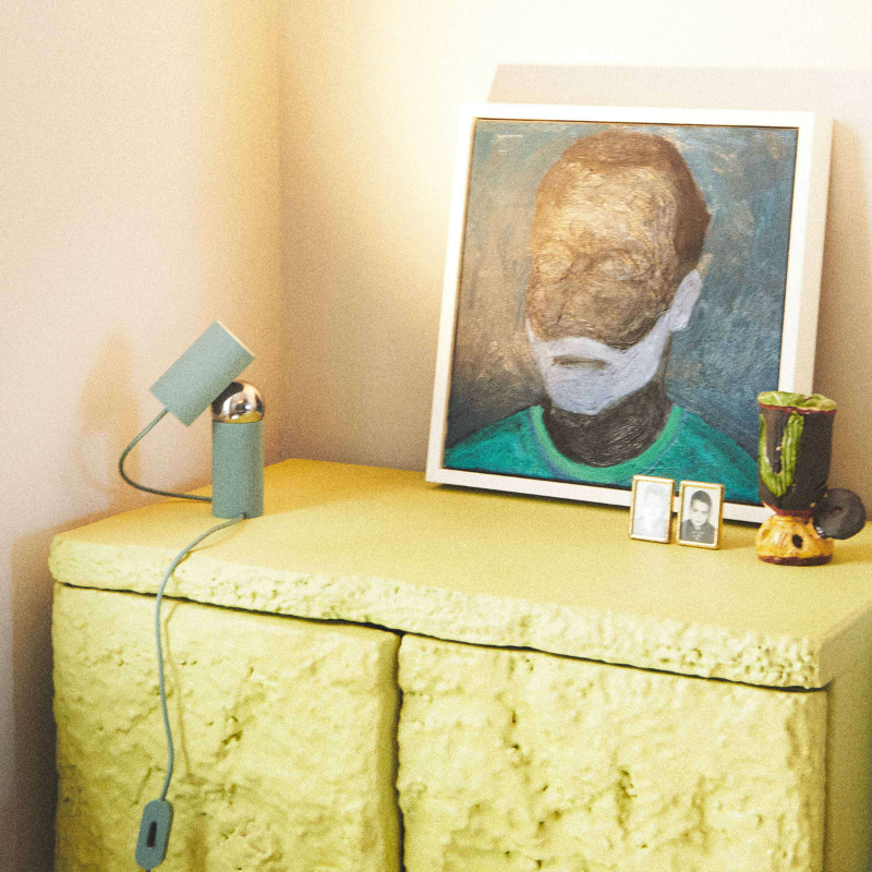 The Bilboquet Table Lamp from FLOS in sage in a lounge.