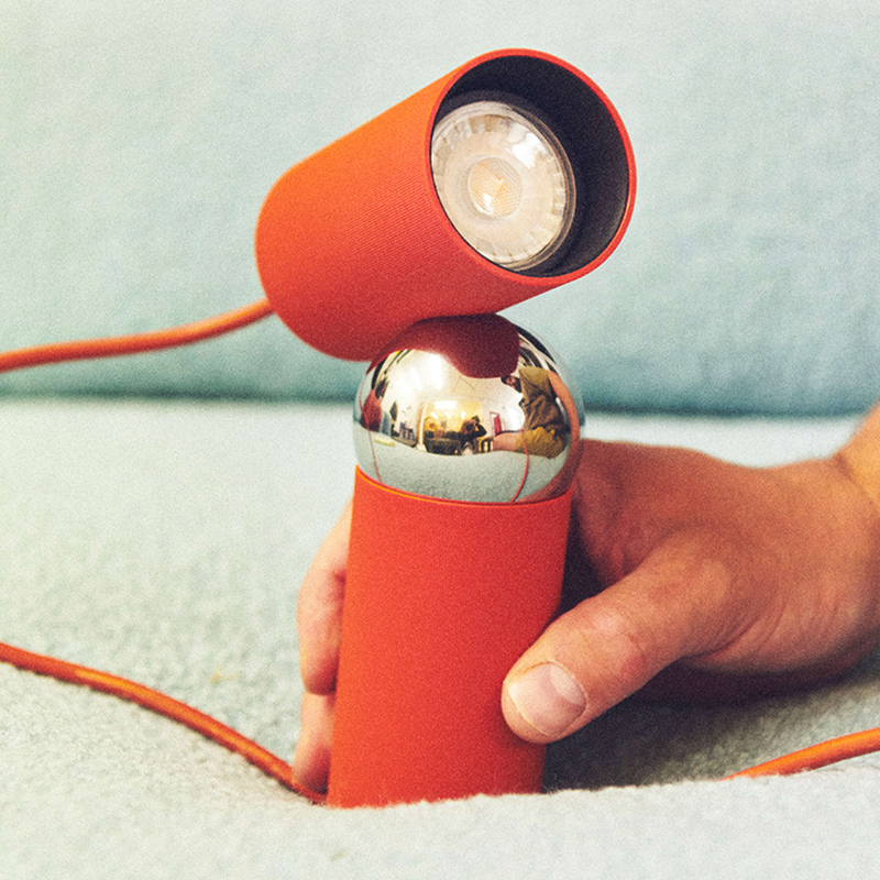The Bilboquet Table Lamp from FLOS in tomato handheld.