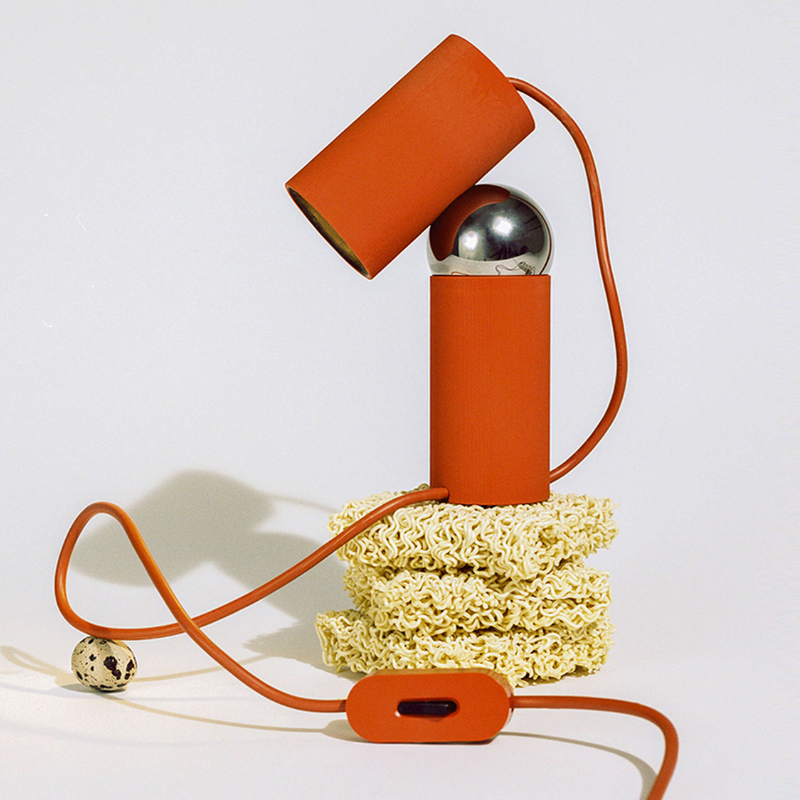 The Bilboquet Table Lamp from FLOS in tomato in a studio.