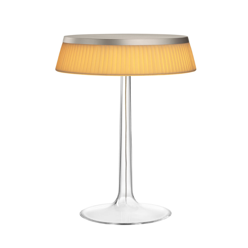 The Bon Jour Table Lamp from Flos in matte chrome with plisse cloth crown.