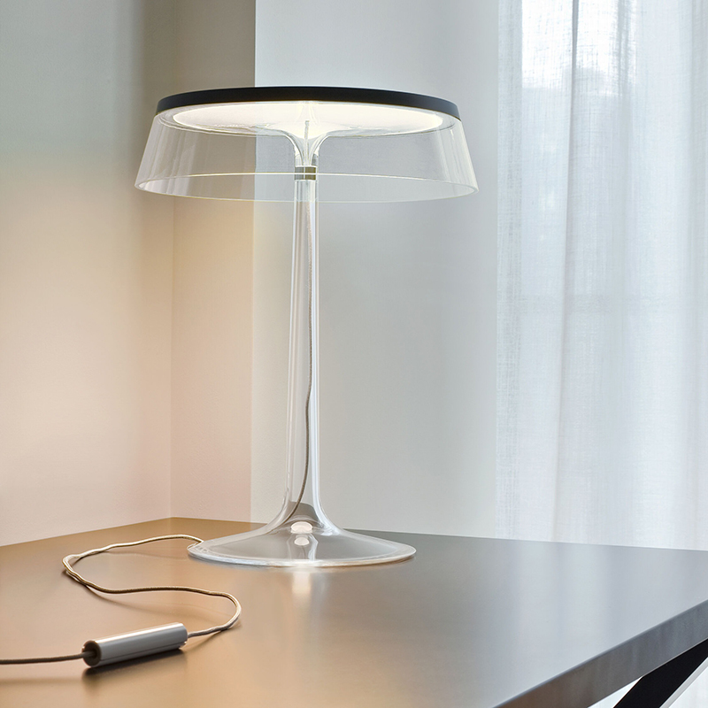 The Bon Jour Table Lamp from Flos in matte chrome with transparent crown in guest bedroom.