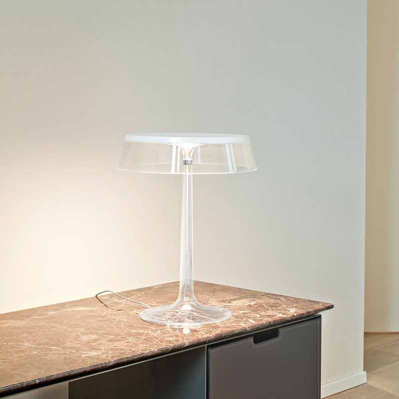 The Bon Jour Table Lamp from Flos in white with transparent crown in a family space.